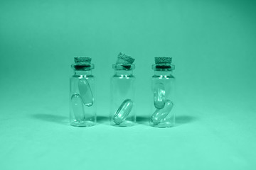 Three glass jars with omega 3 capsules