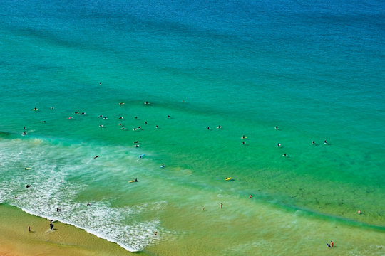 Portugal, Algarve, Arrifana, People Swimming In Green Coastal Waters