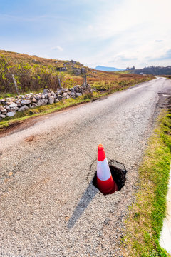 Traffic Cone In Pot Hole On Road, Isle Of Skye, Highlands, Scotland, UK