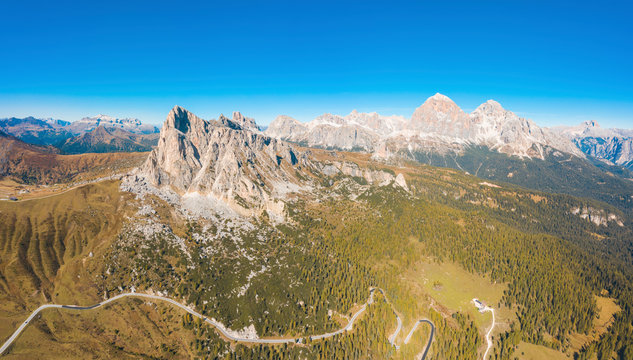 Aerial view of Giau pass and mountains against clear blue sky, Belluno, Italy - Powered by Adobe