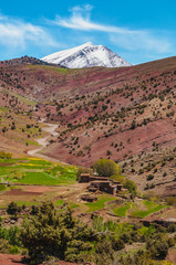 View of adobe village in the high snow-capped mountains in the Aït Bouguemez valley in Morocco