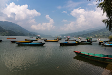 Fototapeta premium Phewa Lake a Cloudy Day and wooden color Boats