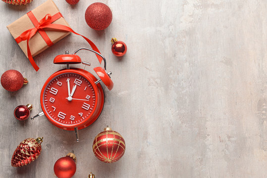 Alarm clock and decor on light background. Christmas countdown concept