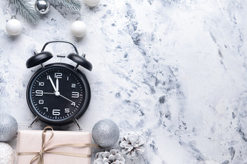 Alarm clock and decor on light background. Christmas countdown concept