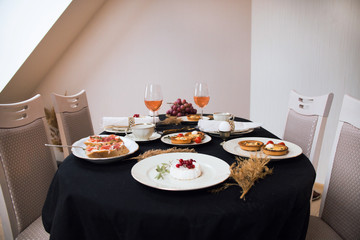 dining table and comfortable chairs in vintage style with elegant table setting