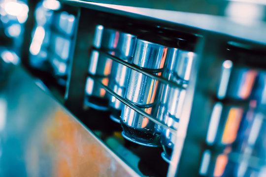 Conveyor belt with tin beer cans. Automated production of beer beverage, beverage bottling in cans.