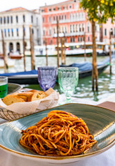 Pasta spaghetti bolognese in Venice, Italy at outside terrace restaurant on the grand canal. Tradidional italian food.