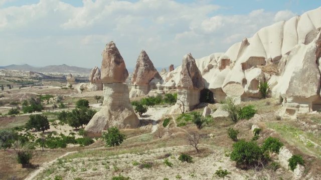 Cappadocia, famous rocks in Goreme National Park and Love Valley at summer sunny day / Aerial drone view
