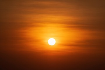 Beautiful sunset over sea. Tranquil scene of Closeup red sun and red sky sunset over the ocean