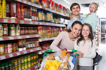 Positive family with two daughters shopping