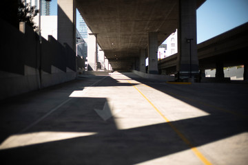Highway Bus Ramp under freeway to Bay Bridge with sun and shadow bad blue sky