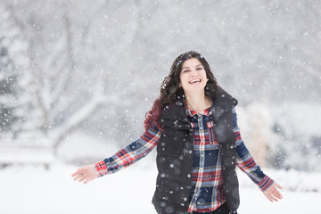 Fototapeta na wymiar Young woman dancing in snow