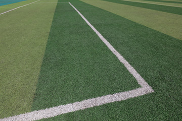 White markings on the green runway