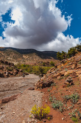 View of adobe house in the high snow-capped mountains in the Aït Bouguemez valley in Morocco