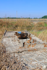 Fototapeta premium The broken wooden boat is on land