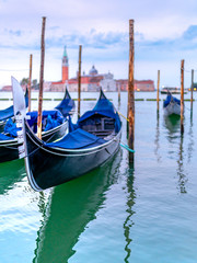 Fototapeta premium Gondolas on water in Venice, Italy. With Church of San Giorgio Maggiore in the background. 