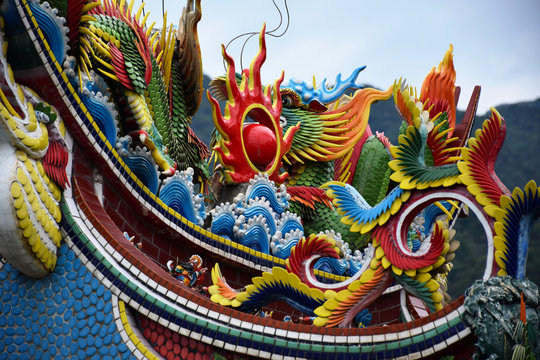 Yilan City, Taiwan - May 12 2017: Close up of a rooftop of a Taiwanese temple with colorful painted dragons