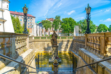 The fountain of St Stanislaus with Holy Water spring, Krakow, Poland. Church of St Michael the...