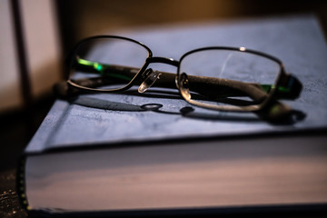 closeup of glasses stacked on a book