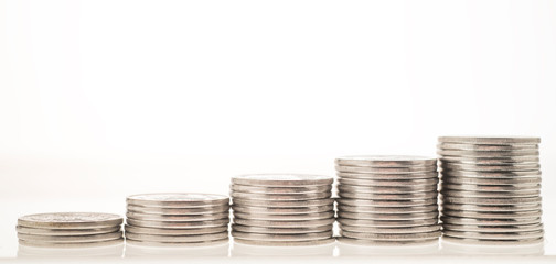 columns of coins close-up on a white and colored backgrounds