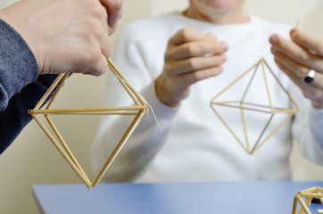 Making the straw decorations named spiders or himmeli