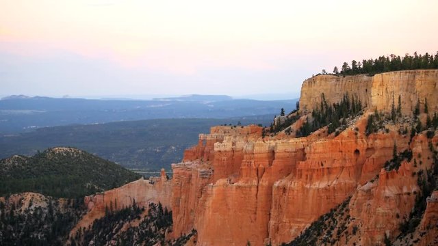 Paria view overlook zooming in on orange pink cliff rock hoodoos in Bryce Canyon National Park in Utah at dark sunset twilight and sunlight on formation