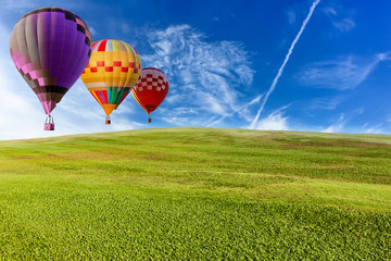 Beautiful landscape hot air balloons flying over grassland and blue sky