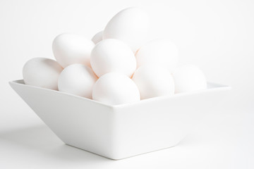 Fototapeta premium Fresh White Eggs Piled On White Square Bowl