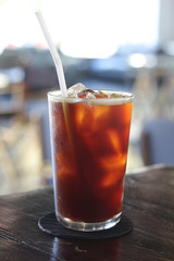 Iced americano coffee with ice on table in cafe.