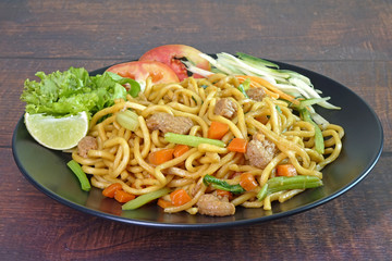 Noodles : Vegetarian stir fried noodle with tofu, carrots and green vegetables. Chinese vegetarian noodle for vegetarian festival.