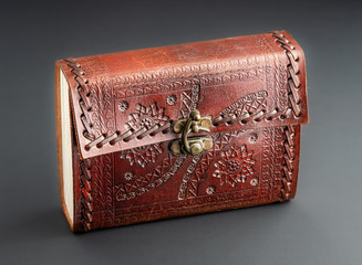 Brown leather notebook journal, stitched and embossed with metallic latch and details on textured leather.