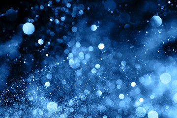 Splash of blue sparkles on black background. Color of the year 2020 concept. - 307529998