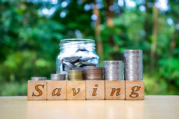 Coins placed on wooden signs, blocks and messages save the concept of saving money and saving money...