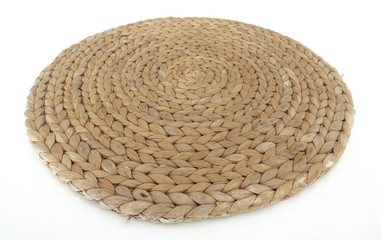 Fototapeta na wymiar Texture of handmade round beige wicker tablecloth surface isolated on white background; Close-up of single oval water mat of water hyacinth fabric. Rustic appearance Heat-resistant. Environmentally f
