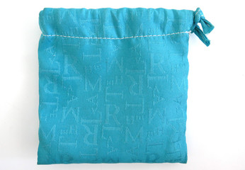 Isolated light blue 100% cotton bag. Canvas fabric with letters. Drawstring bag  White background.