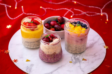 Chia pudding and fresh fruit smoothie, mango, berry, cherry with christmas decoration