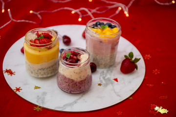 Chia pudding and fresh fruit smoothie, mango, berry, cherry with christmas decoration
