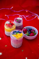 Chia pudding and fresh fruit smoothie, mango, berry, cherry with christmas decoration