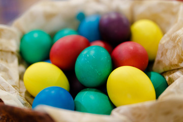 Close-up. Painted Easter eggs lie in a wicker basket.