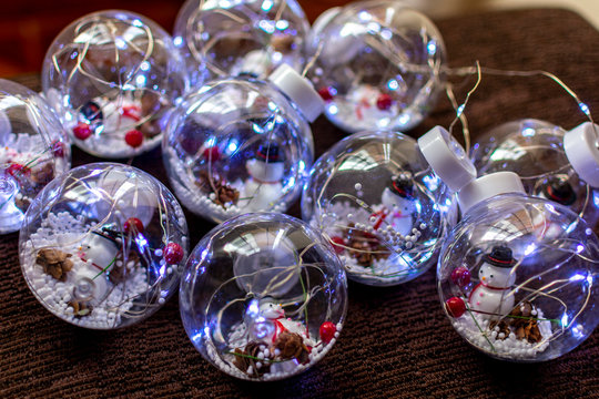 Snowman Inside A Festive Bubble With Lots Of Snow With Colorful Lights