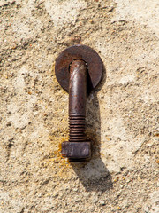 Rusty Bent Nut and Bolt in Concrete