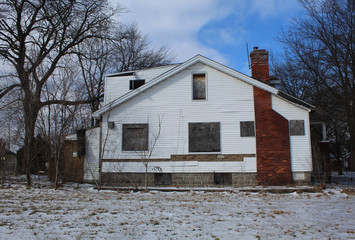 Abandoned and boarded up home in Detroit's Martin Park neighborhood in winter