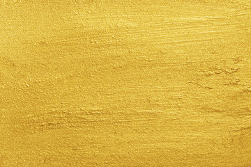 Golden background. Metallic yellow color painted rough surface texture
