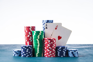 stack of poker chips with two aces on a white background isolate