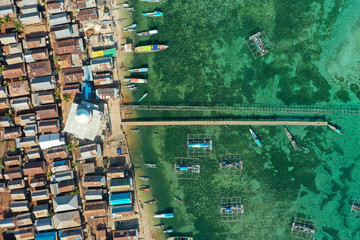 Aerial and top view the beautiful blue ocean and fisherman village at the remote island called...