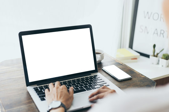 mockup image blank screen computer,cell phone with white background for advertising text,hand man using laptop texting mobile contact business search information on desk in office.marketing and design