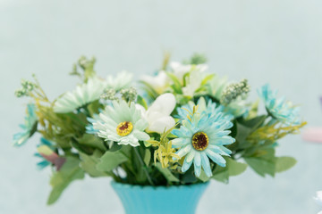 Obraz premium Close up of beautiful bouquet of white roses on blue background and blurred lights. Focus selective.