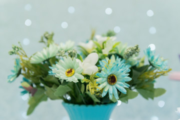 Close up of beautiful bouquet of white roses on blue background and blurred lights. Focus selective.