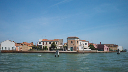 Fototapeta na wymiar Buildings of Murano by water, in Venice, Italy