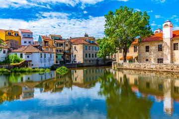 Old buildings in Viseu reflected on a local creek, Portugal - obrazy, fototapety, plakaty